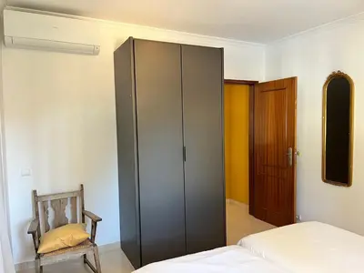 a bedroom with a gray cabinet and a bed at Villa Nox in Brejos