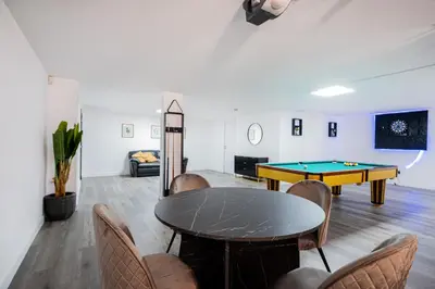 a living room with a pool table and a couch at Villa Thetis by Atlantic Places in Albufeira