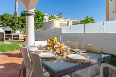 a blue table with a bowl of fruit on a patio at Villa Thetis by Atlantic Places in Albufeira