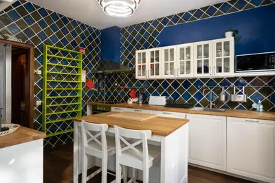 a kitchen with white cabinets and a wooden table at Holiday villa in elite residential area of Faro in Faro