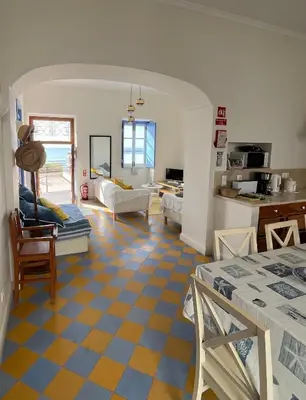 a living room with a yellow and blue checkered floor at Casa da Praia in Albufeira