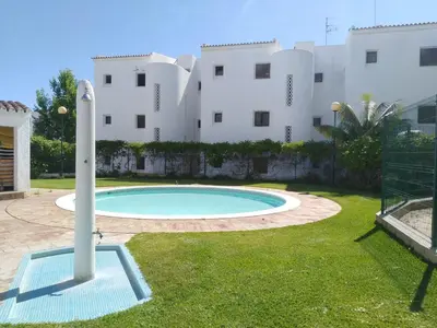 a swimming pool in front of a building at Garden View Vilamoura Apartment in Vilamoura