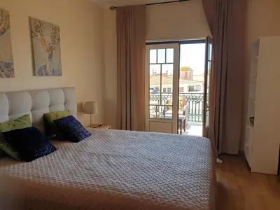 a bedroom with a bed and a door to a balcony at Oura Beach T1 apartment Coral , close to the Strip, Swimming Pool, Wi Fi, A/C in Albufeira