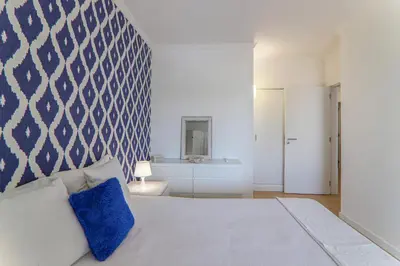 a bedroom with a bed with a blue and white wall at Refugio Salgados in Galé