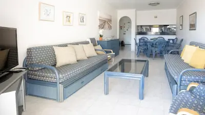 a table with chairs and a bowl of grapes on it at Palmeira Gale - WIFI - Pool - Lux - BY BEDZY in Albufeira