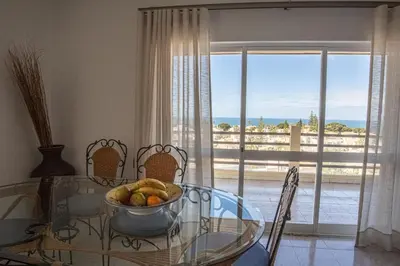a dining room with a glass table with a bowl of fruit at Palmeira Gale - WIFI - Pool - Lux - BY BEDZY in Albufeira