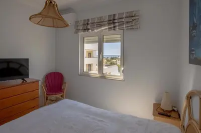 a bedroom with a bed and a window at Apartamento Palmeira Gale - Beach - Pool - BY BEDZY in Albufeira