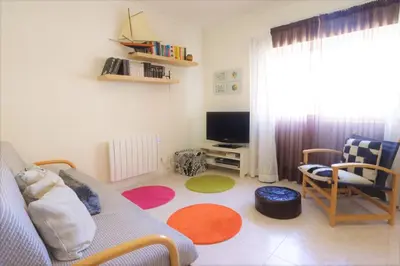 a living room with a couch and a tv at Apartamento Palmeira Gale - Beach - Pool - BY BEDZY in Albufeira