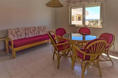 a living room with a couch and a table and chairs at Apartamento Palmeira Gale - Beach - Pool - BY BEDZY in Albufeira