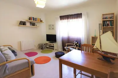 a living room with a couch and a table at Apartamento Palmeira Gale - Beach - Pool - BY BEDZY in Albufeira