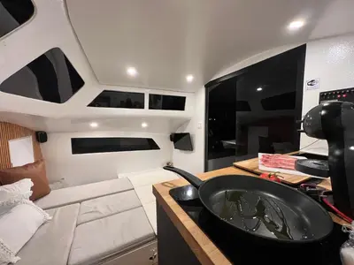 a boat sitting on the water at night at Barco Casa Catamarã Sleepandboat in Faro
