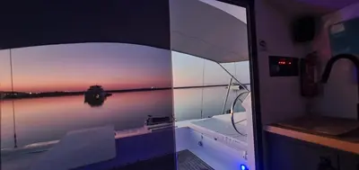 a boat sitting in the water at night at Barco Casa Catamarã Sleepandboat in Faro
