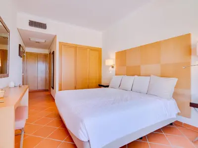 a hotel room with a large bed and a bathroom at AL - Apartamento Vila Sol F5 AE in Vilamoura