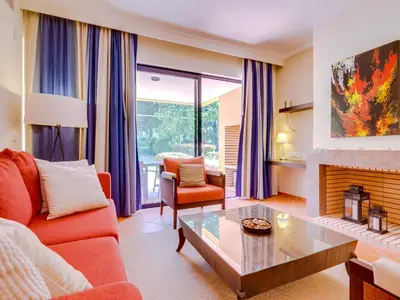 a living room with a couch and a fireplace at AL - Apartamento Vila Sol F5 AE in Vilamoura
