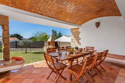 a dining room with a wooden table and chairs at Villa Casa Tina by Villa Plus in Albufeira