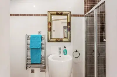 a bathroom with a sink and a mirror and a shower at Villa Casa Tina by Villa Plus in Albufeira