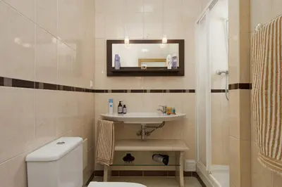 a bathroom with a sink and a toilet and a mirror at Villa Cubos by Villa Plus in Albufeira