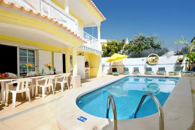 a swimming pool in front of a house at Villa Cubos by Villa Plus in Albufeira