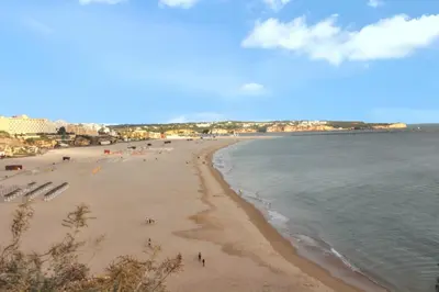 a view of a beach with people on it at Charming Apartment in Vilamoura with Shared Pool - 70 m² in Vilamoura