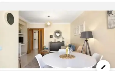 a living room with a white table and chairs at Charming Apartment in Vilamoura with Shared Pool - 70 m² in Vilamoura