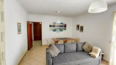 a living room with a couch and a television at Apartamento Canaima in Quarteira