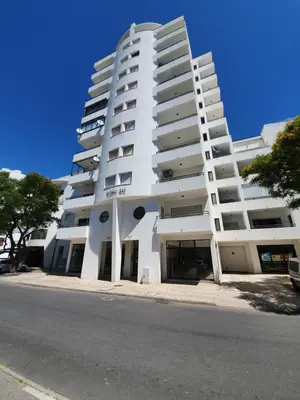 a white building with the words metropolitan hub on it at Apartamento Canaima in Quarteira
