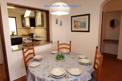 a dining room table with a blue and white table cloth at São Rafael - Hydrangea 5, Apt. T2 - Albufeira in Albufeira