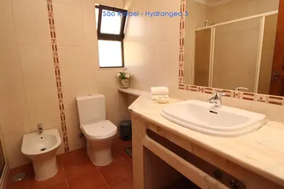 a bathroom with a sink and a toilet at São Rafael - Hydrangea 5, Apt. T2 - Albufeira in Albufeira