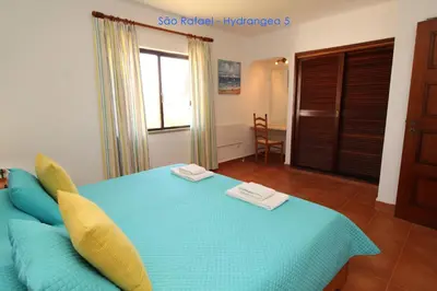 a bedroom with a blue bed with two towels on it at São Rafael - Hydrangea 5, Apt. T2 - Albufeira in Albufeira