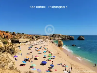 a group of people on a beach with umbrellas at São Rafael - Hydrangea 5, Apt. T2 - Albufeira in Albufeira