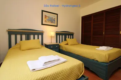 two beds sitting next to each other in a room at São Rafael - Hydrangea 5, Apt. T2 - Albufeira in Albufeira