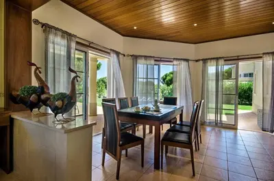 a dining room with a table and chairs at Villa Palm Golfe, fantastic house on Vila Sol course, kids pool, aircon in Quarteira