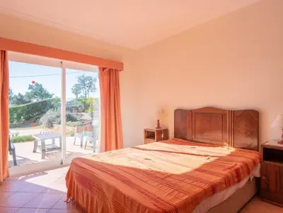 a bedroom with a bed and a large window at Villa Agua - Modern villa, quiet location walkable to restaurant and supermarket in Guia