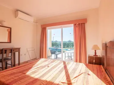 a bedroom with a bed and a view of a patio at Villa Agua - Modern villa, quiet location walkable to restaurant and supermarket in Guia