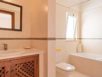 a bathroom with a sink and a toilet and a bath tub at Villa Agua - Modern villa, quiet location walkable to restaurant and supermarket in Guia