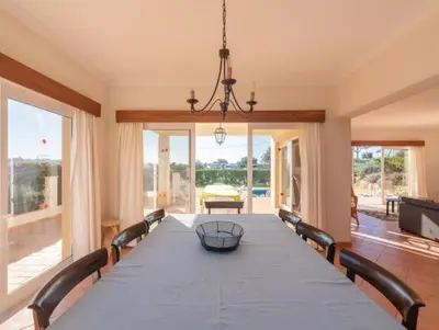 a dining room with a long table and chairs at Villa Agua - Modern villa, quiet location walkable to restaurant and supermarket in Guia