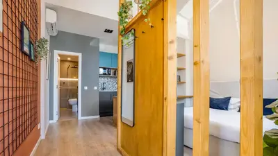 a room with a bed and a hallway with a bunk room at Hostellicious Studio in Faro