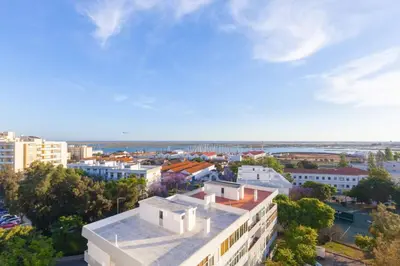 an aerial view of a city with a building at Sunset entre a Ria e o Teatro in Faro