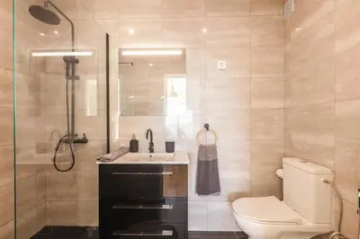 a bathroom with a toilet and a sink and a shower at Sunset entre a Ria e o Teatro in Faro