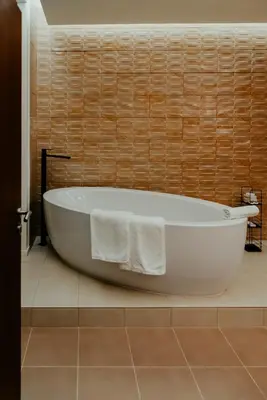 a white bath tub sitting in a bathroom at Happy House Comfort Plus in Faro