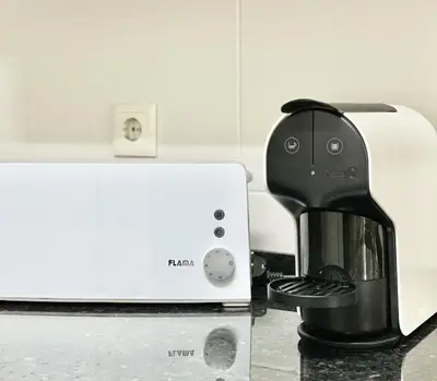a black coffee maker sitting next to a toaster at Miral 1 - Apartment 100m to the beach by HD PROPERTIES - Quarteira in Quarteira