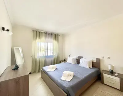a bedroom with a bed with two towels on it at Miral 1 - Apartment 100m to the beach by HD PROPERTIES - Quarteira in Quarteira