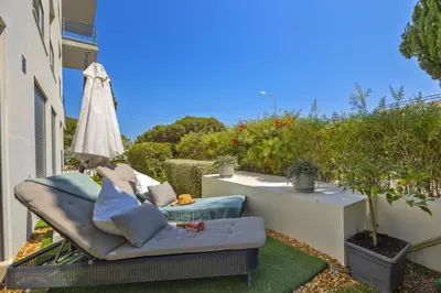 a couch sitting on the side of a balcony at Cavalo Preto Beach Residence with Garden & Pool in Quarteira