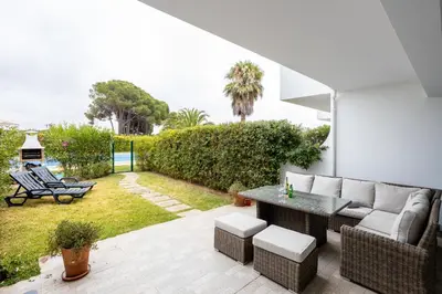 a patio with a couch and a table at Casa Primavera in Albufeira