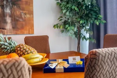 a table with a bowl of fruit and a box of presents at Duplex Sea View by Albufeira Holidays in Albufeira