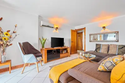 a living room with a couch and a tv at Duplex Sea View by Albufeira Holidays in Albufeira