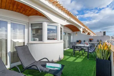 an outdoor patio with a table and chairs on a balcony at Duplex Sea View by Albufeira Holidays in Albufeira