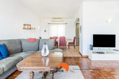 a living room with a couch and a tv at #052 V4 Mimosas by Home Holidays in Albufeira