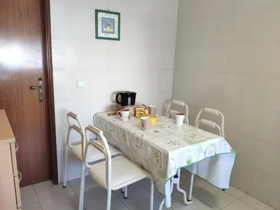 a dining room table with chairs and a tablecloth on it at Apartamento Jardim de Sta Eulália in Albufeira