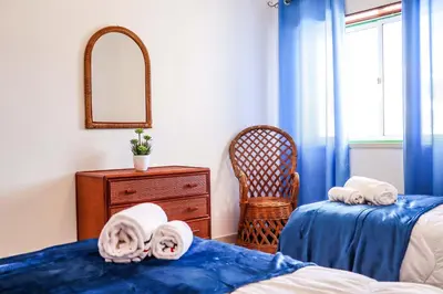 a bedroom with two beds and a mirror and a dresser at Apartamento Jardim de Sta Eulália in Albufeira